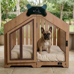 Natural oak dog house shown outdoors with a French Bulldog enjoying the cozy cushion. Perfect as an indoor or covered patio dog crate. Sturdy wooden structure, clear panels, and modern design create a safe and stylish space for your dog. Ideal for small and medium breeds. Premium pet furniture built for comfort, durability, and beautiful home presentation.