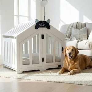 Modern white indoor dog house styled in a bright, cozy living room. This luxury wooden dog crate offers comfort for medium and large breeds, shown here with a Golden Retriever. Clear panels, solid structure, and a plush cushion create the perfect safe space. Designed as premium pet furniture that blends beautifully with light, airy home décor.