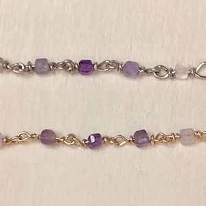 May include: Two delicate chains with alternating amethyst and clear beads, each chain ending with a small loop.