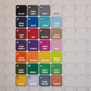May include: A color chart featuring a grid of small, square color swatches. Each swatch is labeled with a color name, including black, white, blue, red, green, and more. The chart is designed for color selection and comparison.