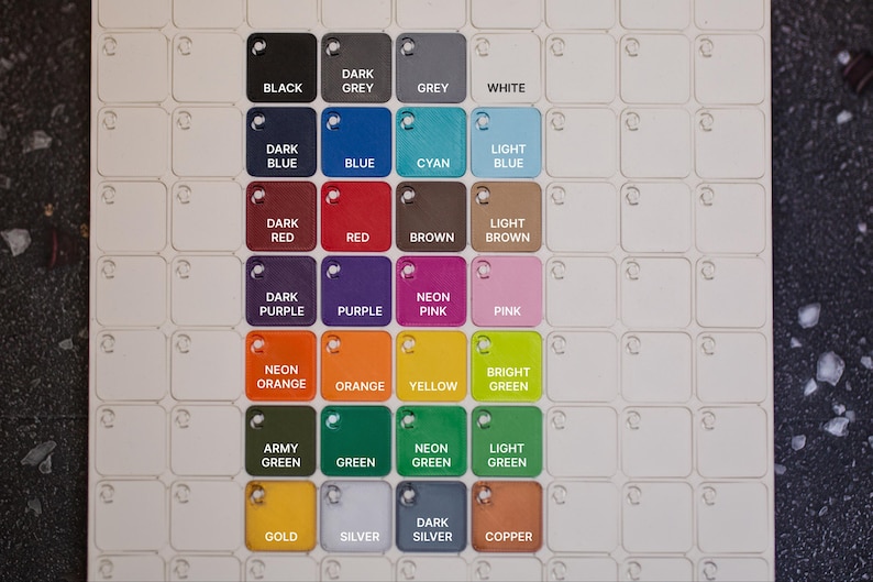 May include: A color chart featuring a grid of small, square color swatches. Each swatch is labeled with a color name, including black, white, blue, red, green, and more. The chart is designed for color selection and comparison.