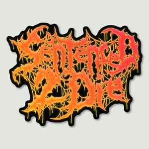 May include: A black and yellow sticker with the word "SLAUGHTERED" in a dripping, stylized font. The letters are filled with a gradient of orange and red.