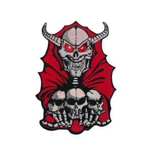 May include: An embroidered patch featuring a skeletal figure with red eyes and horns, holding three skulls in its hands. The patch is red and white.