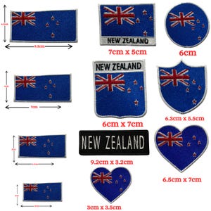 May include: A collection of embroidered patches featuring the New Zealand flag in various shapes including rectangles, circles, shields, and hearts. Some patches include the text NEW ZEALAND. Dimensions range from 3cm by 2cm to 9.5cm by 4.5cm.
