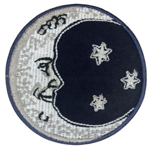 May include: A white crescent moon with a face and three white stars on a dark blue background. The moon and stars are embroidered on a circular patch.
