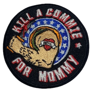 May include: A black and red embroidered patch with the text "KILL A COMMIE FOR MOMMY" in a circle. The patch features a stylized arm with a heart tattoo that says "MOM" inside.