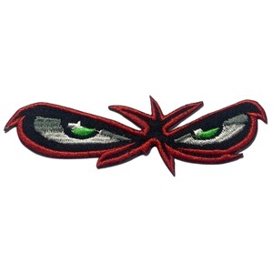 May include: Red and black embroidered patch with two green eyes and a starburst design.