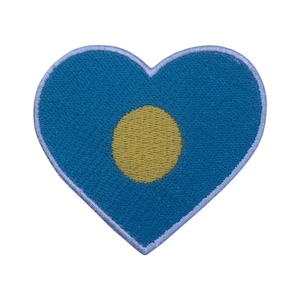 May include: A blue heart-shaped patch with a yellow circle in the center.