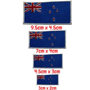May include: Four blue rectangular patches featuring the New Zealand flag. The patches are of varying sizes, with the largest measuring 9.5cm x 4.5cm and the smallest 3cm x 2cm. The flag has the Union Jack and four red stars.