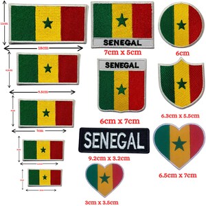 May include: A collection of Senegal flag patches in various shapes and sizes. The patches feature the green, yellow, and red colors of the Senegalese flag, with a green star in the center. Some patches have the word "SENEGAL" on them.