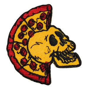 May include: A yellow skull with a red and yellow pizza slice on top. The skull is winking and has a toothy grin. The pizza slice has red pepperoni.