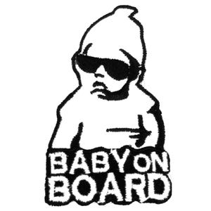 May include: Black and white embroidered patch depicting a baby in sunglasses and a beanie. The words "BABY ON BOARD" are stitched in bold capital letters beneath the baby. The patch has a textured, stitched appearance.
