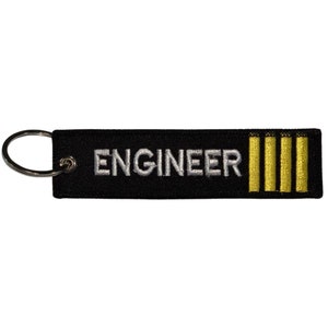 May include: Black fabric keychain with a white embroidered word "ENGINEER" and three gold stripes.