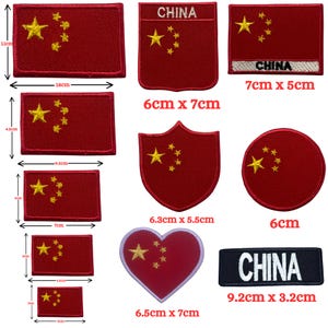 May include: A selection of iron-on patches featuring the flag of China in various shapes and sizes, including a rectangle, shield, circle, heart, and a rectangular patch with the word "CHINA" in white text on a black background. The patches range in size from 6 cm to 9.2 cm.