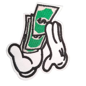 May include: White cartoon hand holding a stack of green bills. The hand is outlined in black and the bills have a black outline. The bills are folded in half and have a green background with a black outline.