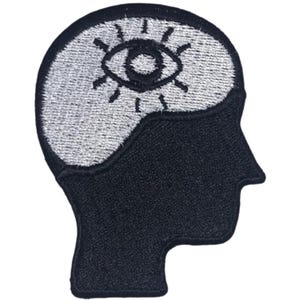 May include: Embroidered patch featuring a black silhouette of a head. The top section is filled with a silver-coloured design of an eye with radiating lines. The patch is designed to be sewn onto fabric.
