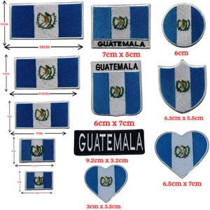 May include: A selection of Guatemala flag patches in different shapes. The patches display the Guatemalan coat of arms on a white stripe between two blue stripes. Sizes vary from 3 cm to 18 cm in length.