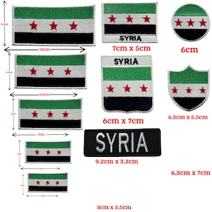 May include: A selection of Syria flag patches in various shapes, including rectangular, circular, and shield designs. The patches display the Syrian flag's green, white, and black stripes with three red stars. Some patches have the word "SYRIA".