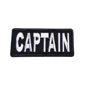May include: Black embroidered patch with white lettering that reads "CAPTAIN".