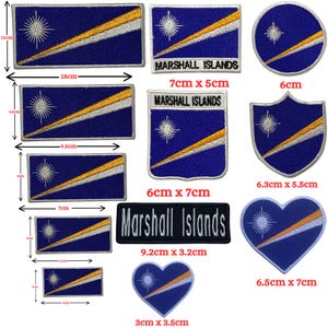 May include: A collection of embroidered patches featuring the flag of the Marshall Islands. The patches are in various shapes, including rectangles, circles, and hearts. The flag design includes a blue background, a white star, a yellow and white diagonal stripe, and the text "Marshall Islands".
