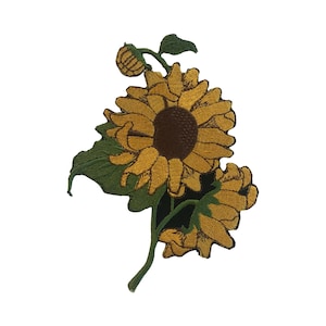 May include: An embroidered sunflower patch in yellow and green with a brown centre. The sunflower is on a white background.
