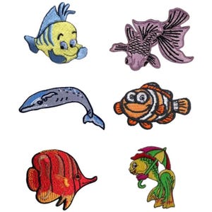 May include: A selection of embroidered patches depicting cartoon fish. Designs include a yellow and blue fish, a purple fish with flowing fins, a grey whale, an orange and white clownfish, a red fish, and a green fish with an umbrella.