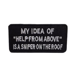 May include: Black embroidered patch with white text that reads "My idea of "help from above" is a sniper on the roof."