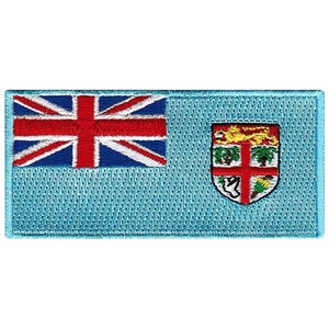 May include: An embroidered patch of the Fijian flag. The flag is light blue with a Union Jack in the top left corner and the Fijian coat of arms in the bottom right corner.