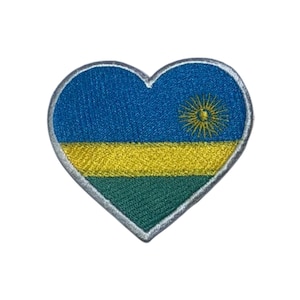 May include: A heart-shaped embroidered patch featuring the flag of Rwanda. The flag is blue with a yellow horizontal stripe and a green horizontal stripe. A yellow sun with a red center is in the upper right corner of the blue section.