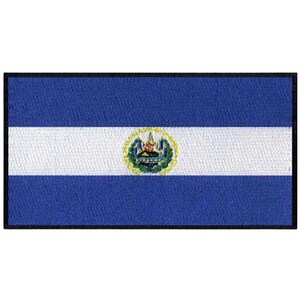 May include: A blue and white flag with a coat of arms in the center. The coat of arms features a green tree, a blue lake, and a yellow crown.