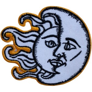 May include: Embroidered patch featuring a sun and moon design. The sun is depicted as a face with flowing hair, while the moon is a crescent shape with a face. The sun is outlined in gold, while the moon is outlined in black.