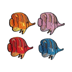 May include: Four embroidered iron-on patches of colourful butterfly fish. The patches are orange, pink, red, and blue.