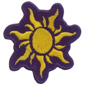 May include: Purple embroidered patch with a yellow sun and rays.