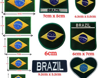 May include: A collection of embroidered patches featuring the Brazilian flag in various shapes and sizes, including rectangular, circular, shield, and heart designs. Some patches include the text BRAZIL, with dimensions ranging from 3cm to 18cm.