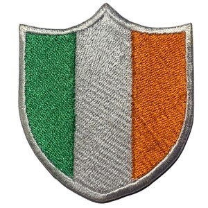 May include: An embroidered patch in the shape of a shield with the colors of the Irish flag: green, white, and orange.