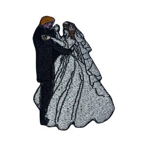 May include: Embroidered patch depicting a bride and groom dancing, the bride is wearing a white dress and veil, the groom is wearing a black suit.