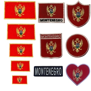 May include: A collection of embroidered patches featuring the red and gold coat of arms of Montenegro with a double-headed eagle. The set includes rectangular, shield-shaped, circular, and heart-shaped patches, some with the text MONTENEGRO.