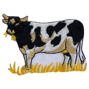 May include: An embroidered iron-on patch of a black and white cow standing in a field of yellow grass.