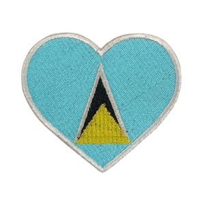 Può includere: Una toppa a forma di cuore blu con la bandiera di Santa Lucia al centro. La bandiera è un triangolo giallo con un triangolo nero all'interno.