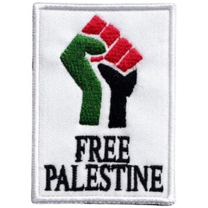 May include: White patch with a black, green, and red fist raised in the air. The text "FREE PALESTINE" is below the fist.