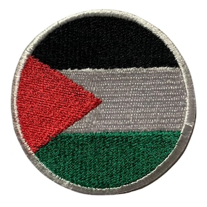 May include: A round embroidered patch featuring the Palestinian flag. The flag is black, white, green, and red. The patch is white with a white border.