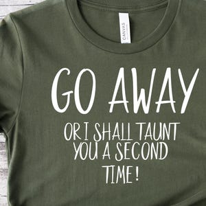 May include: A green t-shirt with the text "Go Away or I shall taunt you a second time!" printed in white.