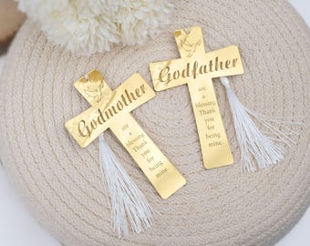 May include: Two gold cross-shaped bookmarks with white tassels. The bookmarks have the words "Godmother" and "Godfather" engraved on them. The text on each bookmark reads "are a blessing Thank you for being mine."
