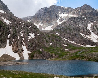 Mountain lake and rocky mountains. Crystal clear lake in the middle of the rocks. Lake, mount, peak, hill, stone, fields. Interior design