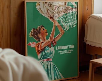 May include: A framed poster featuring a green background and an illustration of a person in a dress holding a laundry basket above their head. The text reads LAUNDRY DAY WHERE SOCKS VANISH AND FUN BEGINS in white capital letters on the right side.