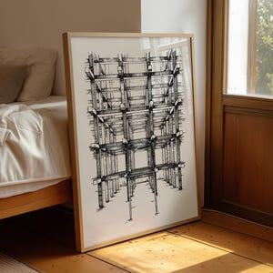 Puede incluir: Un dibujo arquitectónico enmarcado en blanco y negro. La obra de arte representa una estructura detallada, posiblemente el esqueleto de un edificio, con líneas y sombreados intrincados. El marco es de color madera clara y la obra está apoyada contra una pared.