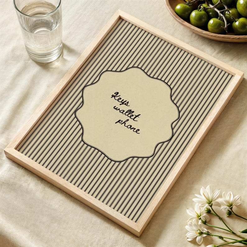 Hand drawn poster with the text "Keys wallet phone" inside a scalloped border on a neutral pinstripe background. Simple modern art used as Functional decor for Apartment decor or an Art for hall.