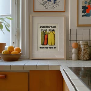 Retro-style digital art print of a green pickle jar with "Just Dill With It" text on a red background, styled as nostalgic kitchen wall decor.