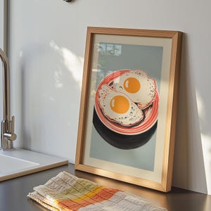 Digital illustration of two fried eggs on a red striped plate with a blue background, styled as mid mod kitchen and pop art egg decor for quirky breakfast wall art.