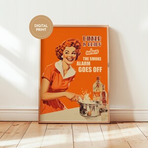 Retro style poster of a smiling housewife in an orange kitchen with a funny quote. Fun kitchen print in a 50s aesthetic for nostalgic decor.
